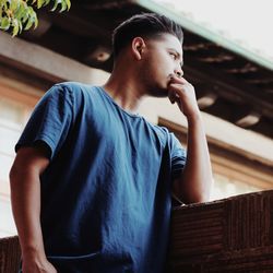 Midsection of man sitting on wood