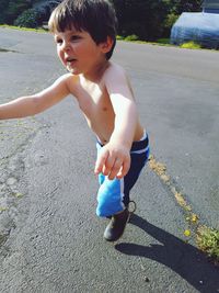 Boy playing on road