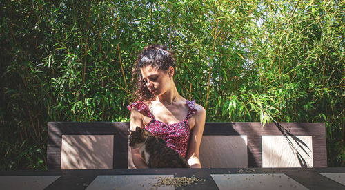 Woman wearing hat against plants