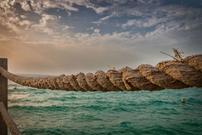 Rocks in sea against sky