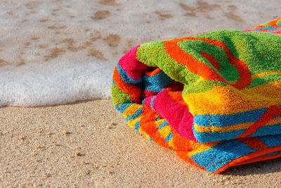 High angle view of multi colored painting on sand