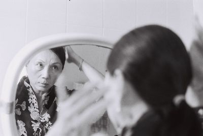 Close-up of young woman with reflection