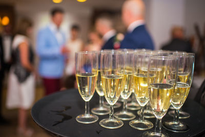 Close-up of wine glasses on tray