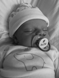 Close-up of baby sleeping in bed