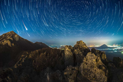 Scenic view of rocks against sky at night