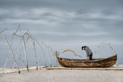 Man in boat by the sea