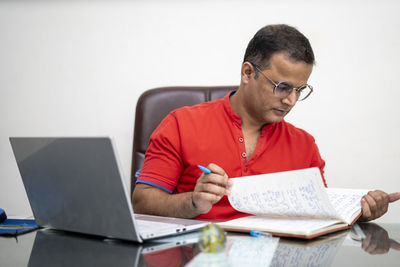 Mid adult man using laptop on table