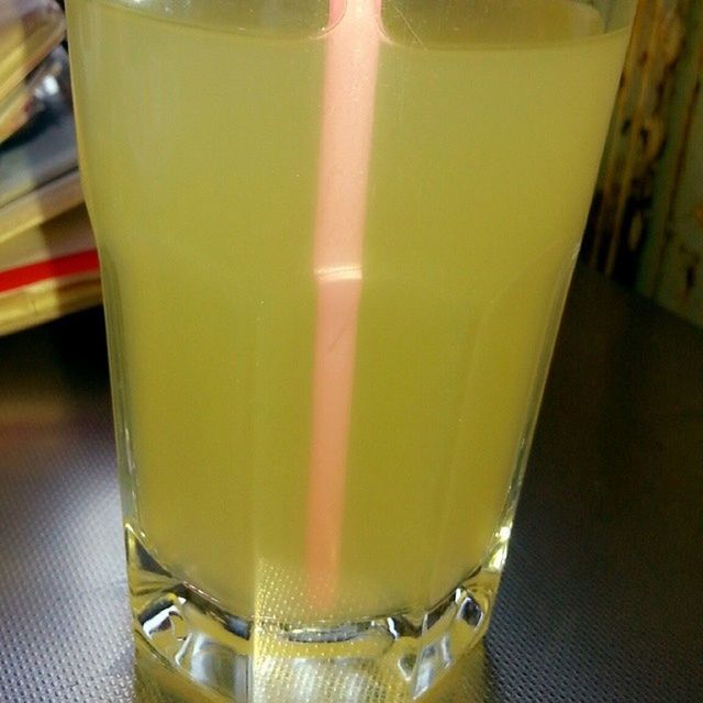 drink, indoors, refreshment, close-up, still life, drinking glass, food and drink, table, yellow, focus on foreground, glass - material, no people, drinking straw, high angle view, freshness, transparent, alcohol, glass, day, selective focus