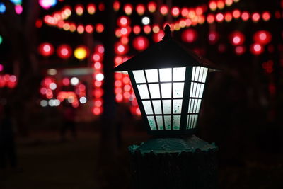 Close-up of illuminated lanterns hanging on ceiling