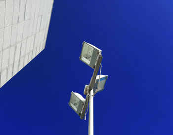 Low angle view of metallic structure against blue sky