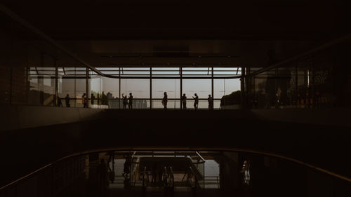 Silhouette people at railroad station