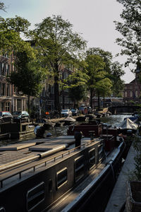 View of canal in city against sky