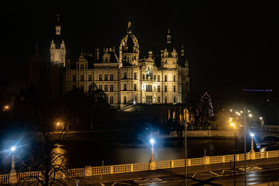 Illuminated buildings in city at night