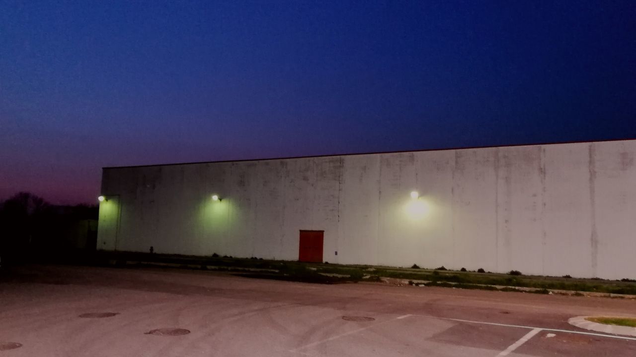 EMPTY ROAD AGAINST CLEAR BLUE SKY AT NIGHT