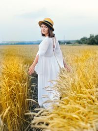 Portrait of woman standing on field