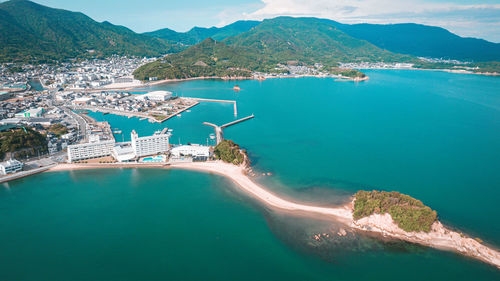 High angle view of sea and mountains against sky