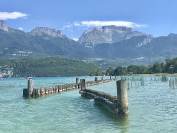 Scenic view of sea and mountains against sky