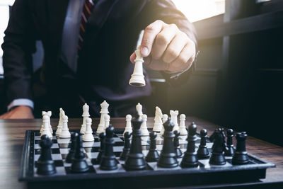 Low angle view of man playing on chess board