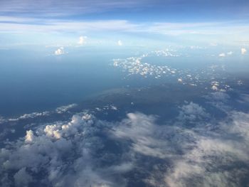 Aerial view of calm sea against cloudy sky