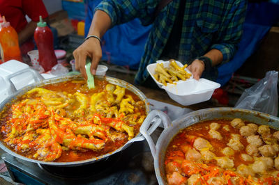 Close-up of man preparing food on cup 