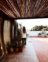 Rear view of woman standing in corridor