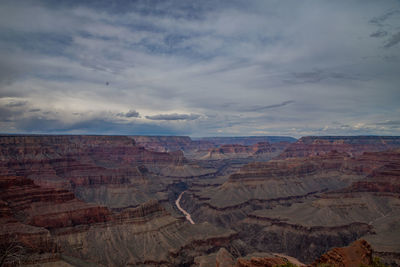 Scenic view of dramatic landscape against cloudy sky