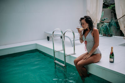 Woman looking at swimming pool