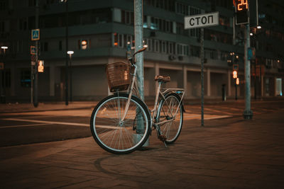 Bicycle parked on street by building