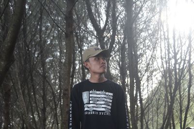 Portrait of teenage girl standing in forest