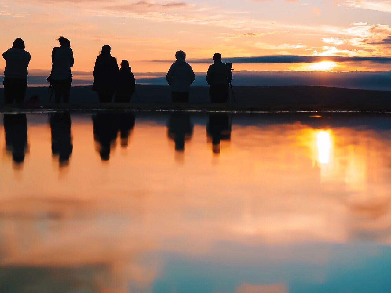 sunset, water, reflection, orange color, silhouette, sky, scenics, beauty in nature, sea, tranquility, tranquil scene, idyllic, waterfront, sun, nature, horizon over water, cloud - sky, men, outdoors