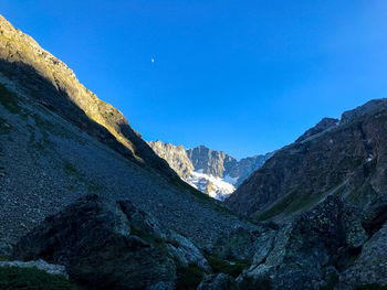 Scenic view of snowcapped mountains against clear blue sky