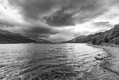 Scenic view of sea against storm clouds