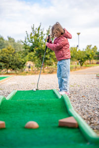 Low section of woman playing golf