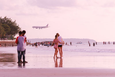 Group of people walking on beach