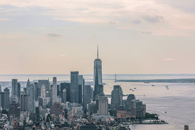 Modern buildings in city against sky during sunset