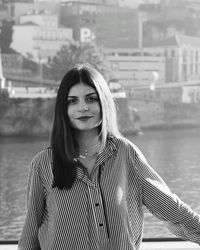 Portrait of a beautiful young woman by water