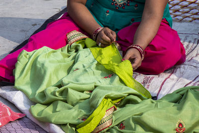 High angle view of woman sitting on leaf