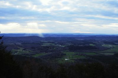 Scenic view of landscape against cloudy sky