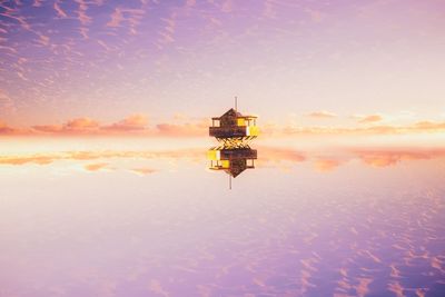 Digital composite image of sea against sky during sunset