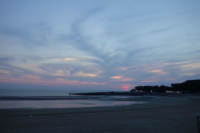 View of beach against cloudy sky