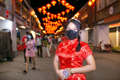 Rear view of woman standing in city