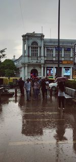 People on wet city street during rainy season