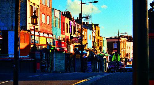 Empty road with buildings in background