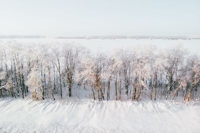 Scenic view of snow covered field against sky