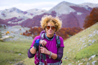 Hiker on the mountain trail explores the area during the autumn season.