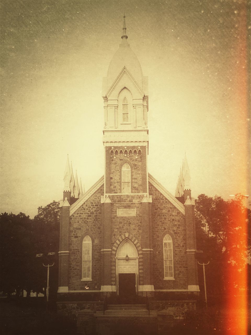 architecture, building exterior, built structure, religion, church, place of worship, spirituality, cathedral, low angle view, cross, sky, tower, clock tower, steeple, clear sky, history, outdoors, window