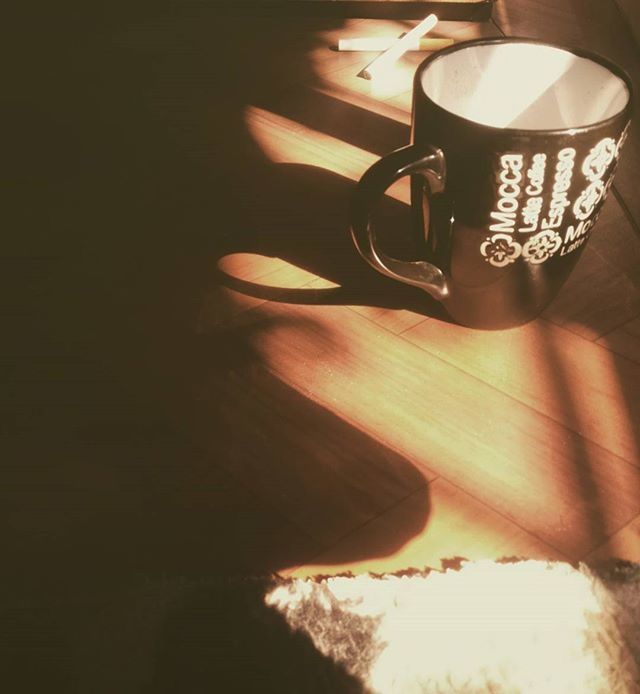 indoors, table, still life, coffee cup, shadow, close-up, no people, home interior, drink, wood - material, absence, wall - building feature, chair, empty, high angle view, sunlight, decoration, cup, vase, hanging