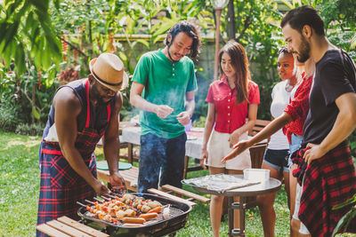 People standing on barbecue grill