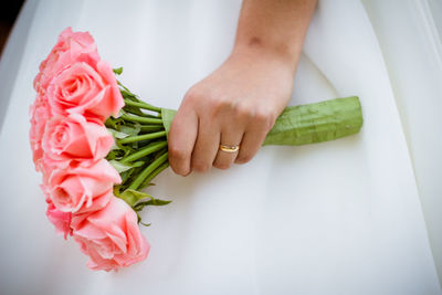 Close-up of hand holding rose bouquet