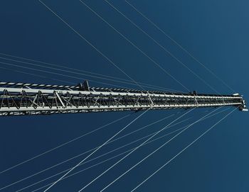 Low angle view of cables against blue sky